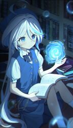 1girl absurdres ahoge alternate_costume blue_bow blue_bowtie blue_eyes blue_hair blue_skirt blue_vest blush book bookshelf bow bowtie chinese_commentary commentary_request flat_chest furina_(genshin_impact) genshin_impact hair_between_eyes hat heterochromia highres indoors library long_hair magic multicolored_hair open_book school_uniform shirt sitting skirt skirt_set smile solo streaked_hair vest white_hair white_shirt yiran_kuxiao