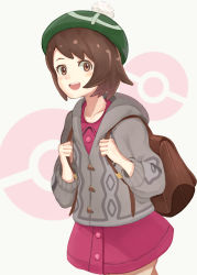 1girl backpack bag blush bob_cut brown_bag brown_eyes brown_hair buttons cable_knit cardigan collared_dress commentary cowboy_shot dress gloria_(pokemon) green_hat grey_cardigan hat holding_strap hood hooded_cardigan long_sleeves looking_at_viewer nintendo open_mouth pink_dress poke_ball pokemon pokemon_swsh pom_pom_(clothes) purea short_hair smile solo tam_o&#039;_shanter white_background