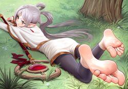 1girl arm_rest barefoot black_pants capelet elf feet feet_up frieren from_behind grass green_eyes grey_hair long_hair looking_at_viewer looking_back lying on_grass on_ground on_stomach outdoors pants pointy_ears puffypinkpaws soles sousou_no_frieren staff_(weapon) the_pose toenails toes twintails white_capelet