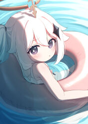 1girl afloat armpit_crease blush closed_mouth commentary from_above from_behind from_side genshin_impact hair_between_eyes hair_flaps hair_ornament hair_tie halo highres in_water innertube looking_at_viewer looking_back matanukinuki paimon_(genshin_impact) ripples short_twintails solo star_(symbol) star_hair_ornament swim_ring swimsuit turning_head twintails upper_body water white_hair