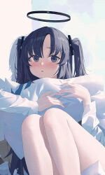 1girl absurdres blue_archive blue_eyes blue_hair blush commentary foot_out_of_frame halo highres hugging_object knees_up lan001 long_hair long_sleeves looking_ahead mechanical_halo pillow pillow_hug reclining solo two_side_up yuuka_(blue_archive)