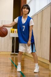 1girl ball basketball basketball_(object) black_hair flat_chest gym highres indoors japanese_(nationality) looking_at_viewer monami_suzu photo_(medium) shoes short_hair smile sneakers standing
