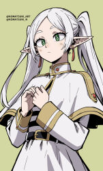 1girl belt black_belt bright_pupils capelet closed_mouth commentary earrings elf frieren gold_trim green_background green_eyes highres jewelry komatsuki_n long_hair long_sleeves own_hands_together pointy_ears simple_background skirt solo sousou_no_frieren standing striped_clothes striped_skirt twintails twitter_username upper_body white_capelet white_hair white_skirt