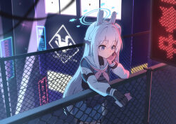 1girl absurdres against_fence animal_ear_headphones animal_ears armor black_gloves blue_archive blue_halo blue_serafuku blue_skirt blush braid building bulletproof_vest chain-link_fence city commentary_request fake_animal_ears fence gloves hair_between_eyes half_up_braid halo hand_on_own_face headphones highres holding holding_phone kuroi_taimu long_hair long_sleeves miyako_(blue_archive) phone pouch purple_eyes rabbit_ears sailor_collar school_uniform serafuku side_ponytail skirt solo tactical_clothes vest white_hair white_sailor_collar
