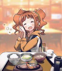 1girl anman_(yxwu7733) blurry blurry_background blush bowl chair closed_eyes cup facing_viewer food hair_ornament hair_scrunchie hands_up highres hood hoodie idolmaster idolmaster_(classic) indoors long_sleeves miso_soup open_mouth orange_hair orange_hoodie own_hands_together restaurant rice scrunchie sitting smile solo takatsuki_yayoi twintails upper_body yellow_scrunchie