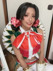 1girl asian brown_hair cosplay cosplay_photo crop_top flower hair_bun hair_flower hair_ornament hat lily_hawk lily_hawk_(cosplay) long_hair looking_at_viewer mexican_clothes photo_(medium) real_life sleeveless street_fighter street_fighter_6 ukaru1207