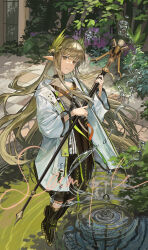 1girl absurdres arknights black_boots boots brown_hair coat commentary_request elf floating foliage full_body highres holding infection_monitor_(arknights) kasumi_yuzuha laurel_crown long_hair looking_at_viewer mole mole_under_eye muelsyse_(arknights) open_clothes open_coat orange_eyes outdoors parted_lips pointy_ears ripples sample_watermark solo very_long_hair water watermark white_coat