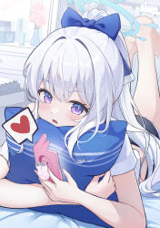 1girl aqua_halo blue_archive blue_bow blush bow cellphone commentary hair_bow halo heart high_ponytail highres holding holding_phone hugging_object indoors long_hair looking_at_phone looking_at_viewer lying miyako_(blue_archive) on_stomach parted_lips phone phone_booth pillow pillow_hug ponytail prana_(prana12) purple_eyes shirt sidelocks solo spoken_heart the_pose white_hair white_shirt