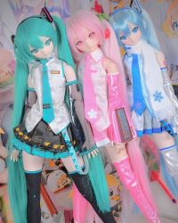 Rule 34 | 3girls, ball jointed doll, bare shoulders, blue eyes, blue hair, cosplay, doll, doll joints, hatsune miku, hatsune miku (cosplay), highres, joints, multiple girls, photo (medium), pink eyes, pink hair, sakura miku, scarf, skirt, sleeve cuffs, thighhighs, vocaloid, yuki miku