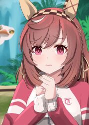 1girl animal_ears bird brown_hair buena_vista_(umamusume) checkered_hairband commentary eakon_7bit ear_covers hairband highres horse_ears horse_girl jacket looking_at_viewer medium_hair ostrich purple_eyes solo tracen_training_uniform track_jacket umamusume upper_body