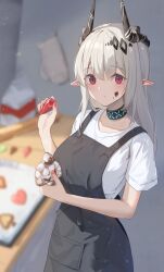 18_yen_coin 1girl alternate_costume apron arknights black_apron black_horns blurry blurry_background chocolate chocolate_on_face commentary_request food food_on_face grey_hair highres holding holding_food horns infection_monitor_(arknights) long_hair looking_at_viewer material_growth mittens mudrock_(arknights) oripathy_lesion_(arknights) pointy_ears red_eyes shirt short_sleeves solo unworn_mittens upper_body white_mittens white_shirt