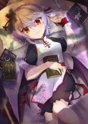 1girl akisome_hatsuka alternate_costume arm_up bat_wings black_bloomers bloomers blush book breasts china_dress chinese_clothes closed_mouth commentary_request dress fang hair_between_eyes hair_ribbon looking_at_viewer low_wings lying on_back pill purple_hair red_eyes red_ribbon remilia_scarlet ribbon short_hair short_sleeves skin_fang small_breasts solo touhou underwear white_dress wings
