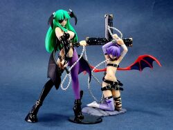 2girls bdsm belt bound bound_arms collar cross cuffs darkstalkers eyepatch figure head_wings kneeling leash lilith_(darkstalkers) morrigan_aensland multiple_girls navel photo_(medium) purple_hair shackles single_thighhigh stomach thighhighs wings