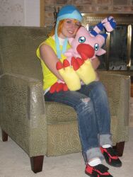 1girl cosplay cosplay_photo couch digimon digimon_adventure looking_at_viewer photo_(medium) real_life sitting stuffed_toy takenouchi_sora teeth