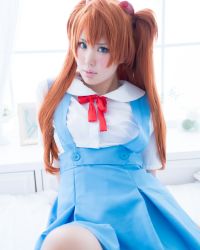 1girl asian blue_eyes breasts cosplay hair_ornament highres japanese_(nationality) lips long_hair looking_at_viewer model neon_genesis_evangelion orange_hair photo_(medium) real_life ririkana school_uniform souryuu_asuka_langley souryuu_asuka_langley_(cosplay) tokyo-3_middle_school_uniform twintails two_side_up upper_body