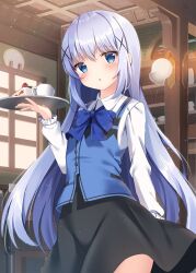 1girl :o arm_at_side black_skirt blue_bow blue_bowtie blue_eyes blue_hair blue_vest blush bow bowtie cafe cake cake_slice child collared_shirt commentary_request cowboy_shot cup food fruit gochuumon_wa_usagi_desu_ka? hair_ornament hand_up highres holding holding_tray indoors kafuu_chino long_hair long_sleeves looking_at_viewer mug open_mouth pizzzica rabbit_house_uniform shirt sidelocks skirt solo strawberry strawberry_cake tray very_long_hair vest white_shirt x_hair_ornament
