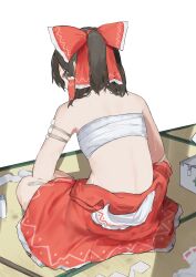 1girl back bandages bandaid black_eyes black_hair bow chest_sarashi first_aid_kit frilled_bow frilled_hair_tubes frills from_behind gauze_on_arm hair_bow hair_tubes hakurei_reimu highres indian_style looking_at_viewer median_furrow pocche-ex ponytail red_bow red_skirt sarashi shirt_down sitting skirt solo sweat touhou