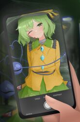 1girl 1other black_hat cellphone collared_shirt green_eyes green_hair green_skirt hat highres holding holding_phone koishi_day komeiji_koishi long_sleeves phone shirt short_hair skirt smartphone stefinat touhou yellow_shirt