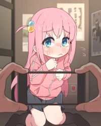 1boy 1girl :c black_skirt black_socks blue_eyes blush bocchi_the_rock! closed_mouth cube_hair_ornament flying_sweatdrops gotoh_hitori hair_ornament highres holding holding_phone jacket kneehighs kneeling long_hair long_sleeves looking_at_viewer nose_blush paid_reward_available phone pink_hair pink_jacket pov pov_hands recording side_ponytail sidelocks skirt socks sweat sweatdrop tamama_(pixiv80097934) track_jacket viewfinder