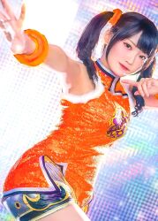 1girl bare_shoulders china_dress chinese_clothes closed_mouth cosplay cosplay_photo dress female_focus highres jewelry ling_xiaoyu ling_xiaoyu_(cosplay) looking_at_viewer orange_dress photo_(medium) real_life short_shorts shorts side_slit sleeveless solo tekken twintails