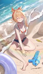1girl absurdres beach bikini bikini_under_clothes blonde_hair breasts cleavage clenched_teeth closed_eyes denim denim_shorts facing_viewer genshin_impact grin highres medium_hair navel outdoors sand sazanami_(re_n_rentaro) shorts sitting smile solo stomach swim_ring swimsuit teeth water_gun yoimiya_(genshin_impact)