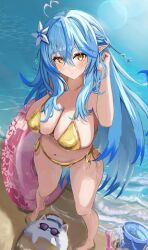1girl absurdres ahoge barefoot beach bikini blue_hair breasts elf full_body gold_bikini golden_week golden_week_bikini gyaru_v heart heart_ahoge highres holding holding_swim_ring hololive innertube large_breasts ocean pointy_ears raised_eyebrows side-tie_bikini_bottom solo_focus standing sun_glare swim_ring swimsuit v virtual_youtuber wet winvita yellow_eyes yukihana_lamy yukimin_(yukihana_lamy)
