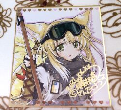 1girl animal_ears arknights black_gloves blonde_hair blush commentary_request expressionless fingerless_gloves fox_ears fox_girl fox_tail fujii_ryou gloves goggles goggles_on_head green_eyes grey_scarf id_card long_hair looking_at_viewer open_mouth scarf shikishi shirt sidelocks simple_background solo suzuran_(arknights) tail upper_body white_background white_shirt