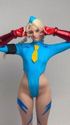 1girl :&lt; bare_legs blonde_hair blue_eyes blue_leotard bodypaint bow bowtie braid brazilian_(nationality) breasts cammy_white cammy_white_(cosplay) cosplay curvy freckles hat highleg highleg_leotard highres indoors leotard long_hair memepantazis parted_lips photo_(medium) real_life simple_background sitting smile street_fighter street_fighter_alpha thong_leotard twin_braids twitter_username v wide_hips