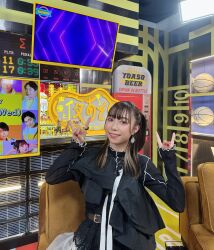 Rule 34 | 1girl, black hair, brown eyes, earrings, flat chest, indoors, japanese (nationality), jewelry, kobayashi aika, looking at viewer, medium hair, official alternate costume, photo (medium), ponytail, real life, red nails, smile, standing, voice actor