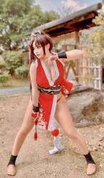 1girl breasts brown_hair cleavage closed_mouth cosplay cosplay_photo fatal_fury female_focus fighting_stance highres large_breasts long_hair photo_(medium) ponytail real_life ririnacos shiranui_mai shiranui_mai_(cosplay) snk solo