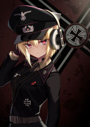 1girl absurdres belt black_gloves blonde_hair cross flag_background gloves hat headphones highres iron_cross jiseki_rena looking_at_viewer military_uniform nazi original peaked_cap red_eyes reichsadler rena_(jiseki_rena) short_hair solo standing throat_microphone totenkopf tsurime