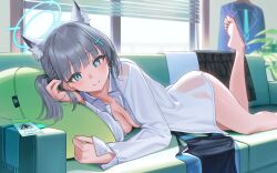 1girl animal_ear_fluff animal_ears bare_legs barefoot window_blinds blue_archive blush breasts cleavage couch earrings feet halo highres id_card indoors jewelry looking_at_viewer lying medium_breasts mismatched_pupils naked_shirt no_pants on_couch on_stomach see-through_clothes shiroko_(blue_archive) shirt side_ponytail skirt unworn_skirt smile soles solo stud_earrings swimsuit unworn_swimsuit toes wolf_ears yasawa_kichi
