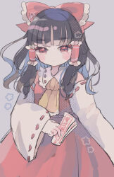 1girl bare_shoulders black_hair blush bow closed_mouth detached_sleeves grey_background hair_tubes hakurei_reimu hiyuu_(hiyualice) holding_ofuda long_hair looking_at_viewer neckerchief red_bow red_eyes red_shirt red_skirt serious shirt skirt solo touhou yellow_neckerchief