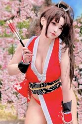 1girl breasts brown_hair cleavage closed_mouth cosplay cosplay_photo fatal_fury female_focus highres large_breasts long_hair looking_at_viewer photo_(medium) ponytail real_life ririnacos shiranui_mai shiranui_mai_(cosplay) snk solo