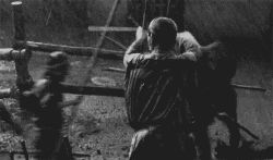 animated animated_gif arrow_(projectile) bow_(weapon) farmer fence lowres monochrome photo_(medium) rain samurai screencap shichinin_no_samurai shimada_kanbei toho warrior weapon