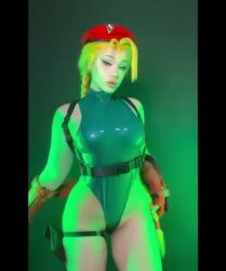 1girl animated ass beanie blonde_hair braid cammy_white cammy_white_(cosplay) cosplay curvy fingerless_gloves from_behind gloves green_leotard hana_cosplay hat highleg highleg_leotard italian_(nationality) leotard long_hair looking_at_viewer parted_lips photo_(medium) real_life revealing_clothes shiny_clothes shiny_skin solo street_fighter tagme thong_leotard twin_braids video wide_hips