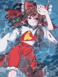 1girl afloat ascot bow brown_eyes brown_hair chest_sarashi commentary detached_sleeves frilled_bow frilled_hair_tubes frilled_skirt frills hair_bow hair_tubes hakurei_reimu highres kasago0217 long_hair looking_at_viewer red_bow red_skirt ribbon-trimmed_sleeves ribbon_trim sarashi shadow skirt skirt_set solo touhou twitter_username water yellow_ascot
