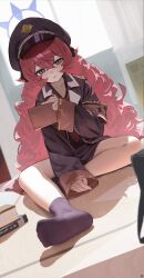 1girl absurdres armband black_hat black_jacket black_shirt black_skirt black_socks blue_archive book commentary_request crossed_bangs fluffy_hair hair_between_eyes halo hat highres holding holding_book indoors iroha_(blue_archive) jacket loli long_hair looking_at_viewer open_mouth peaked_cap purple_eyes purple_halo red_armband red_hair shirt sitting skirt slit_pupils socks soles solo songchuan_li