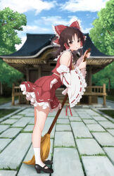 1girl absurdres black_shoes blue_sky bow broom brown_hair building cloud commentary_request day detached_sleeves from_side full_body gibun_(sozoshu) grass hair_bow hair_tubes hakurei_reimu highres holding holding_broom kneehighs legs long_hair mary_janes midriff_peek outdoors red_bow shadow shoes shrine sky socks solo standing touhou tree white_socks
