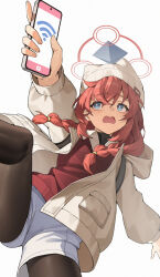 1girl black_thighhighs blue_archive blue_eyes braid bright_pupils cellphone cowboy_shot hat highres holding holding_phone jacket looking_up low_twin_braids maki_(blue_archive) open_mouth phone red_hair red_shirt shi_ling_fangcheng shirt shorts simple_background smartphone solo thighhighs thighs twin_braids white_background white_hat white_jacket white_pupils white_shorts