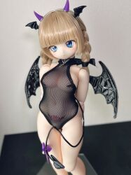 Rule 34 | 1girl, absurdres, arms behind back, blue eyes, figure, fishnet leotard, fishnets, head wings, highres, horns, leotard, photo (medium), pubic tattoo, see-through clothes, see-through leotard, tail, tattoo, wings