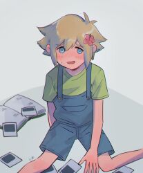 1boy basil_(faraway)_(omori) basil_(omori) blonde_hair blue_eyes blue_overalls flower green_shirt hair_flower hair_ornament highres kokomi_(aniesuakkaman) looking_at_viewer male_focus nervous_smile omori overall_shorts overalls photo_(object) shirt short_hair short_sleeves smile solo sweatdrop t-shirt