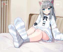 1girl :3 animal_ears blue_eyes blush casley cat_ears feet grey_hair highres indie_virtual_youtuber long_hair looking_at_viewer nachoneko on_bed socks soles striped_clothes striped_socks viewfinder