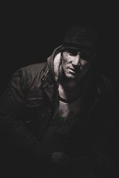 Rule 34 | 1boy, black hood, black jacket, closed mouth, days gone, hat, highres, jacket, looking at viewer, serious, shirt, sitting, skizzo (days gone), solo, white shirt