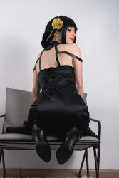 Rule 34 | 1girl, absurdres, ass, black dress, black footwear, black hair, carpet, chair, cosplay, dress, hair flower, full body, gold hairband, golden rose, hair ornament, hair stick, hairband, halter dress, halterneck, high heels, highres, indoors, kneeling, lips, looking back, looking down, mole, photo (medium), smile, solo, spy x family, stelarhoshi, wall, yor briar, yor briar (cosplay)