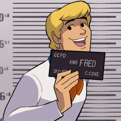 1boy ascot barbie_(franchise) barbie_(live_action) barbie_mugshot_(meme) beth_turnsek blonde_hair card character_name english_text fred_jones height_chart height_mark holding holding_card holding_sign looking_at_viewer male_focus meme mugshot orange_hair scooby-doo short_hair sign solo teeth turtleneck upper_teeth_only