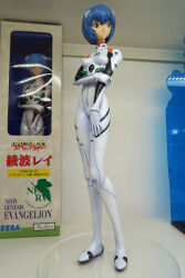 1girl ayanami_rei blue_hair bodysuit figure hair_ornament highres holding_own_arm interface_headset_(evangelion) looking_to_the_side mecha_pilot_suit neon_genesis_evangelion photo_(medium) plugsuit_(evangelion) red_eyes sega short_hair standing white_bodysuit