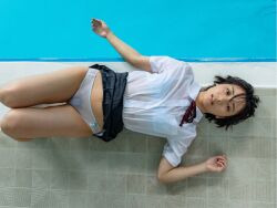 1girl black_hair clothes_lift flat_chest from_above japanese_(nationality) looking_at_viewer looking_up lying monami_suzu on_back on_floor panties photo_(medium) pool poolside pubic_hair school_uniform short_hair skirt skirt_lift underwear wet wet_clothes