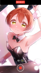 Rule 34 | 1girl, animal ears, black bow, black bowtie, black leotard, black pantyhose, bow, bowtie, breasts, brown hair, commentary request, detached collar, fake animal ears, highres, holding, hoshizora rin, leotard, love live!, love live! school idol project, osono (osonokichi), pantyhose, playboy bunny, rabbit ears, rabbit tail, recording, shadow, short hair, sitting, small breasts, solo, strapless, strapless leotard, tail, user interface, wrist cuffs, yellow eyes, yokozuwari
