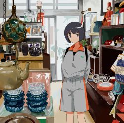 1girl ame_(amemgmgmg) bad_id bad_pixiv_id black_hair cup door feet_out_of_frame grey_shirt grey_shorts highres indoors long_sleeves original reflection shirt short_hair shorts smile solo standing taiwan teapot
